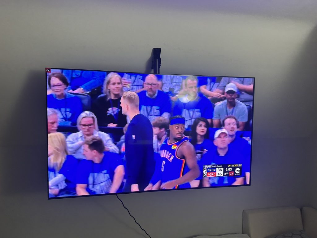 75 inch TV mounted to a sloped ceiling with a specialized ceiling mount bracket in Oceanside, NY