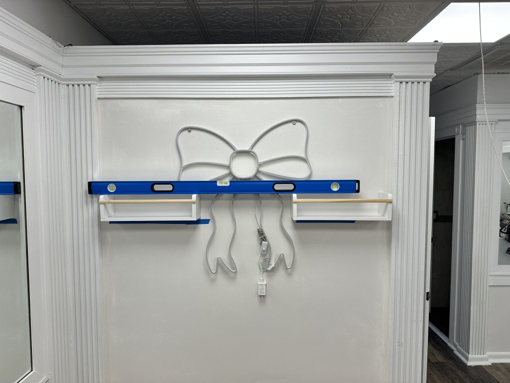 Floating shelves beetwen light sign in Syosset, NY