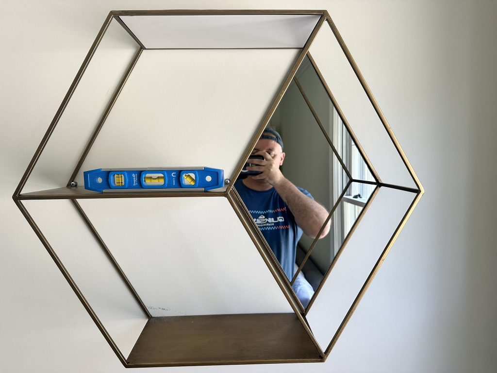Floating shelves with a small mirror in Port Washington, NY