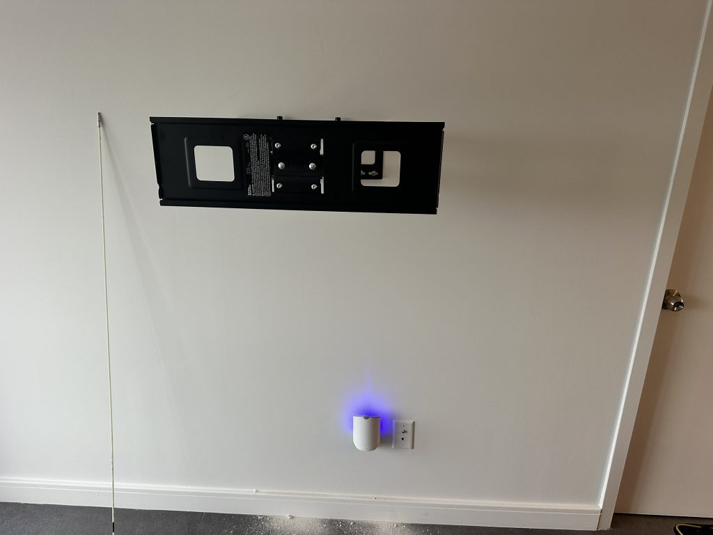 installed full motion mount for a new 65 inch OLED TV with hidden in wall wiring in Garden City, NY
