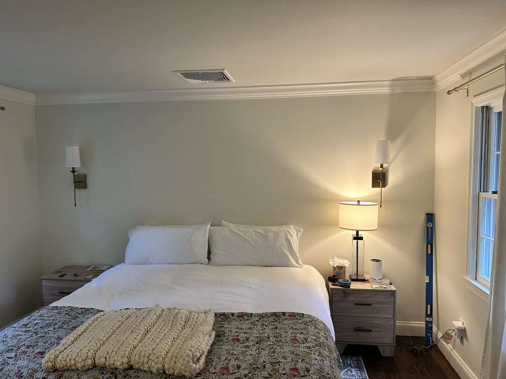 Professional installation of decorative wall sconces in a bedroom in Garden City, NY