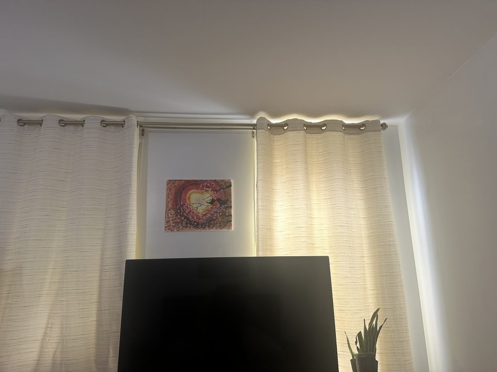 Two textured grommet curtains installed and aligned in a bedroom in Long Beach, NY